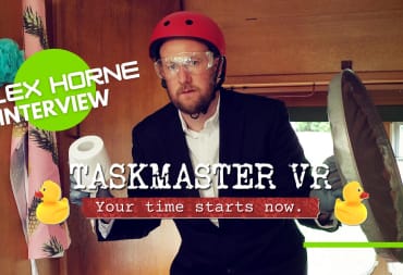 Alex Horne in Taskmaster holding a toilet roll and a garbage can lid while wearing a helmet.