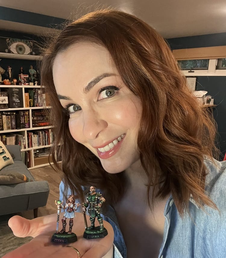 Day showing off miniatures from her shop