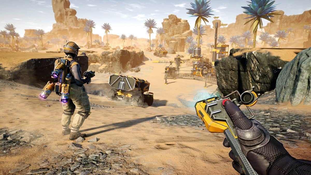 The player looking out over a factory operation alongside a friend in Satisfactory