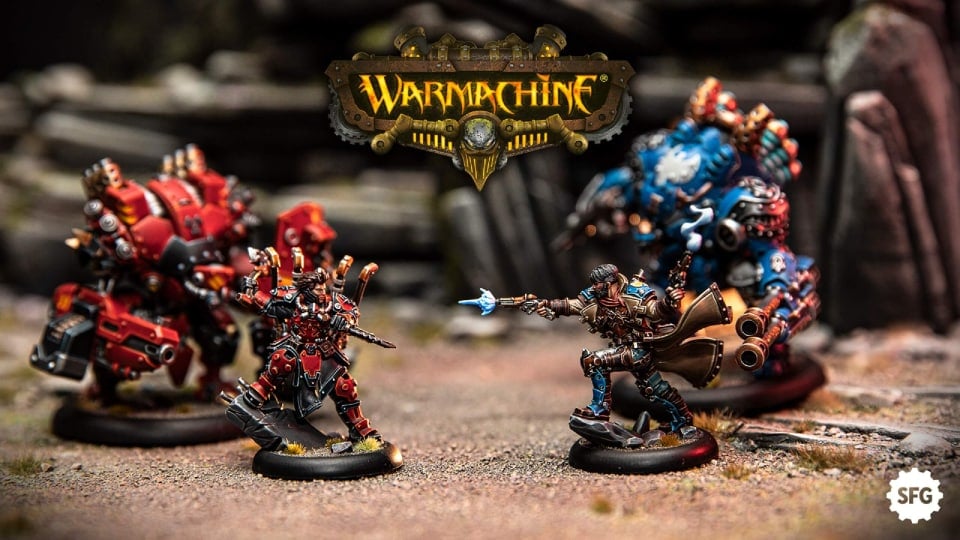 Warmachine miniatures set to battle, with Warmachine title in the middle, and the Steamforged Games logo in the bottom right